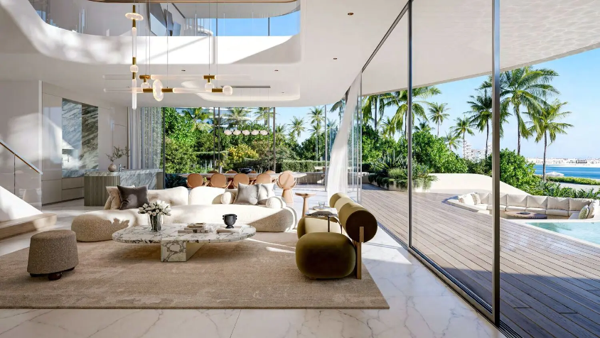 Light-filled open-plan living space surrounded by palm trees and waterfront views at Passo by Beyond.