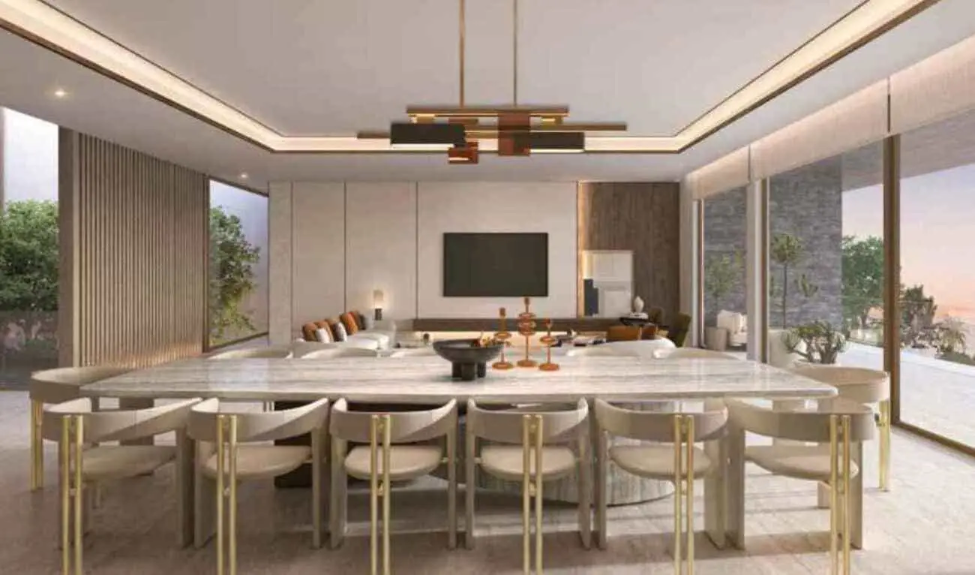Open-plan villa living and dining area with waterfront views and refined interiors.