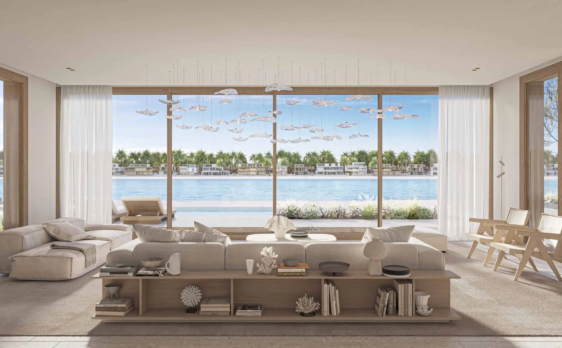 Double-height open-plan living room overlooking private beachfront and infinity pool.