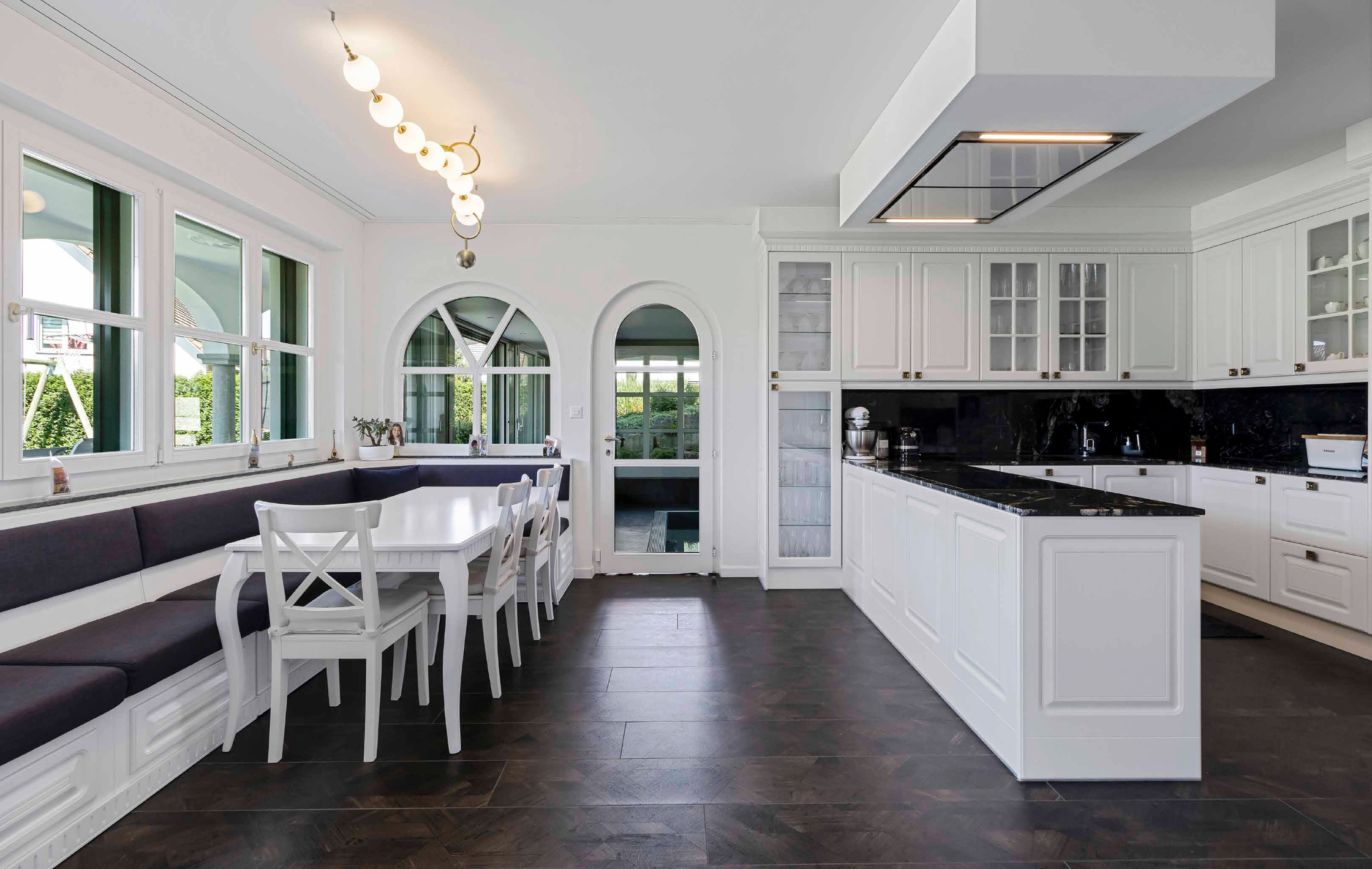 Contemporary designer kitchen with natural lighting and bespoke cabinetry finishes.