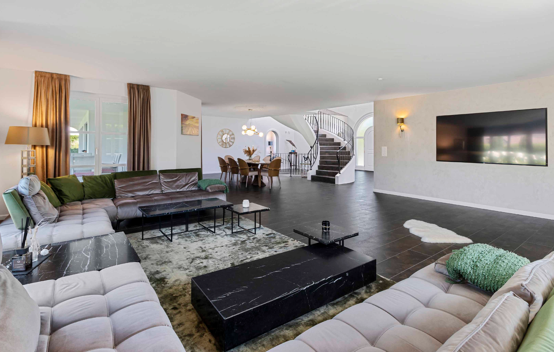 Open-plan luxury living room with natural light and elegant contemporary interiors.
