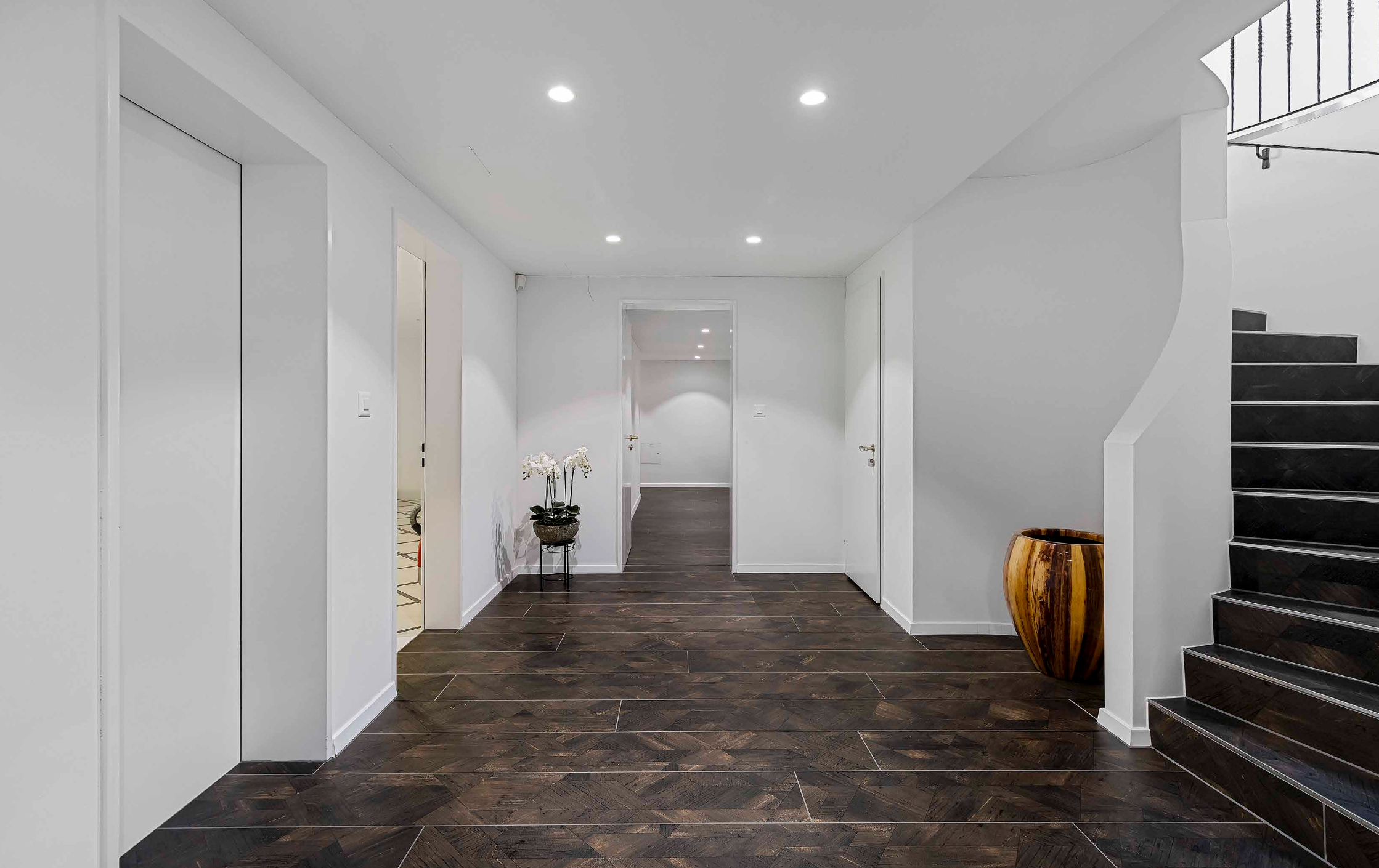 Elegant hallway and staircase with refined architectural detailing and natural light.