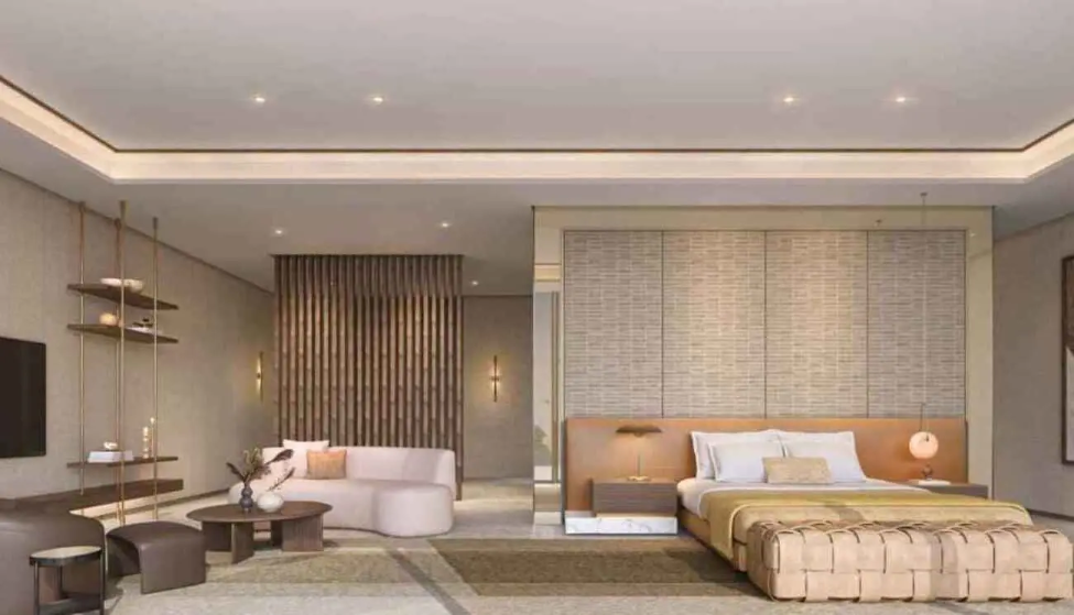 Luxury villa bedroom with lounge seating and soft natural light at Nawayef West.