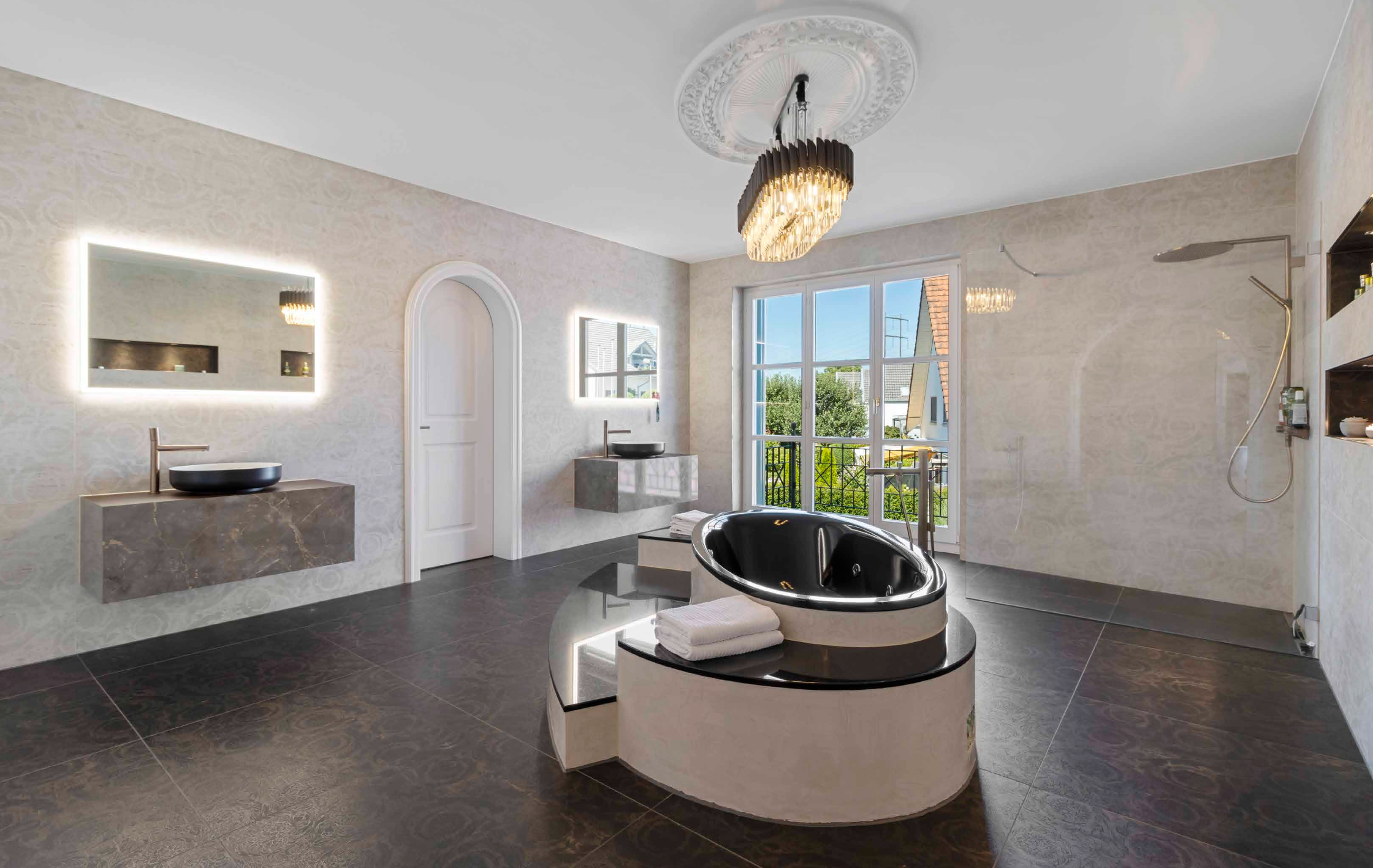Luxury marble-style bathroom with abundant natural light and spa-inspired detailing.