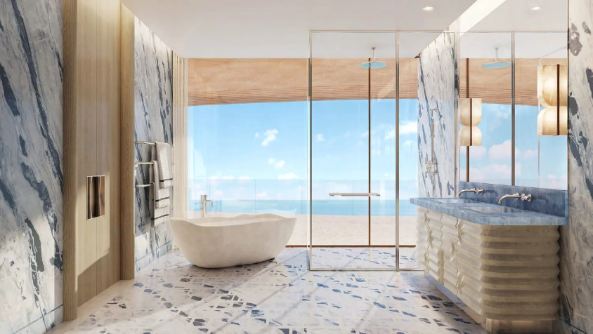Luxury marble bathroom overlooking the waterfront at Jumeirah Asora Bay.