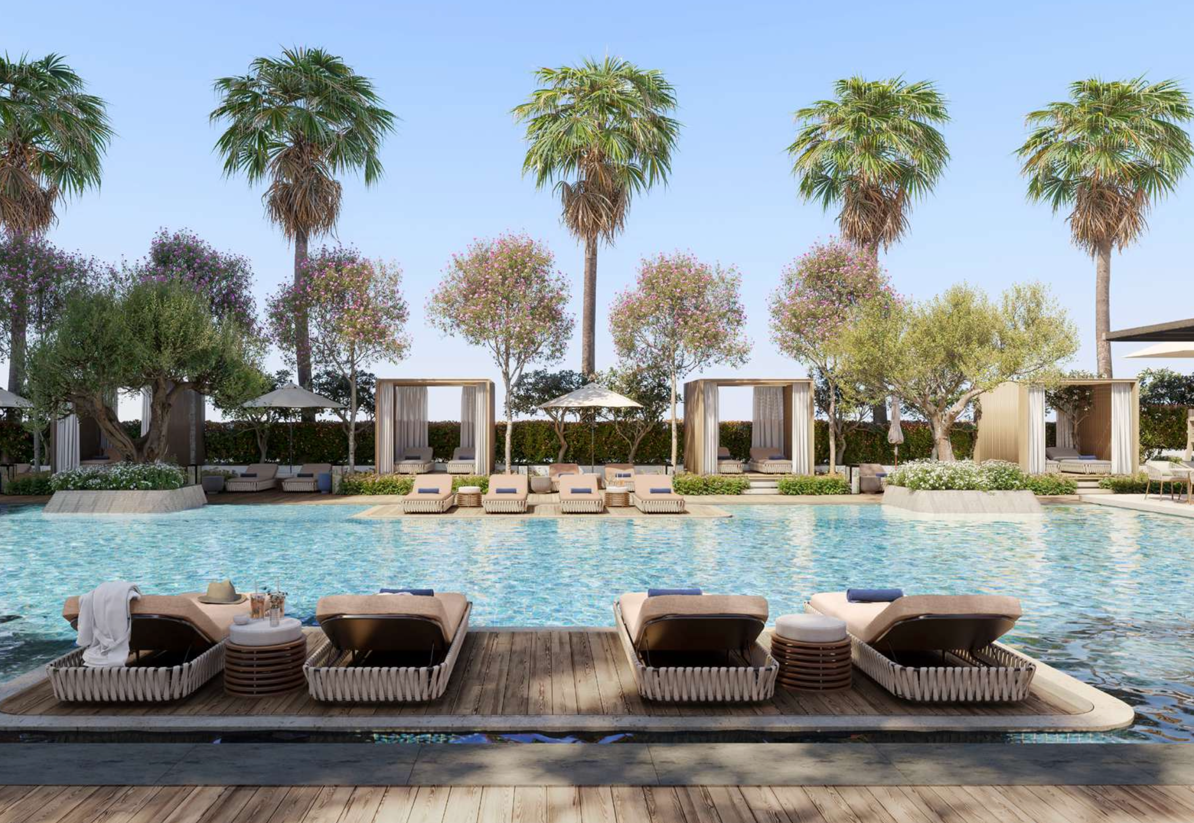 Resort-style outdoor pool deck surrounded by palm trees at Mr. C Residences Downtown